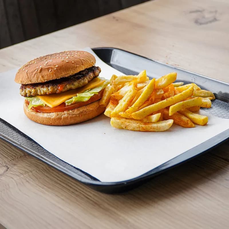 Cheeseburger and fries on a fast-food tray, a reminder that the bun adds wheat to a combo