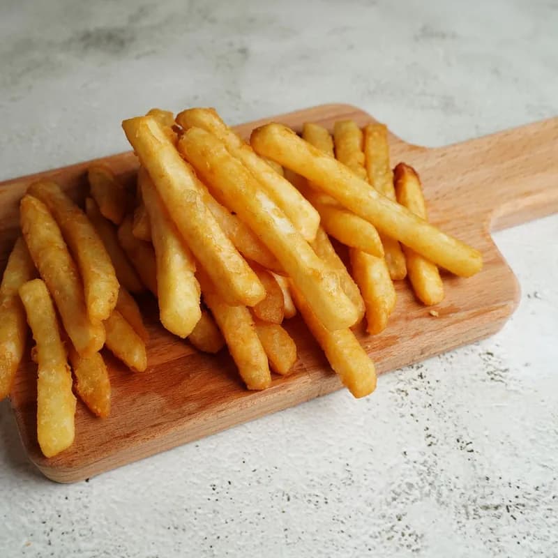 Natural-cut french fries on a wooden board, a close look at gluten free fries by ingredient