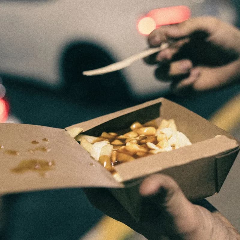 Poutine in a takeout box with fries, gravy, and cheese curds, like Wendy's Canada poutine