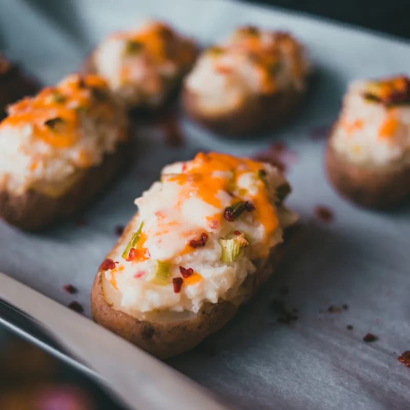 Stuffed baked potatoes with cheese and herbs, similar to a Wendy's cheese baked potato