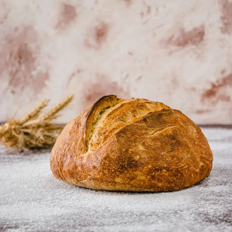 Rustic wheat bread on a floured surface, the main gluten source celiacs avoid at Wendy's