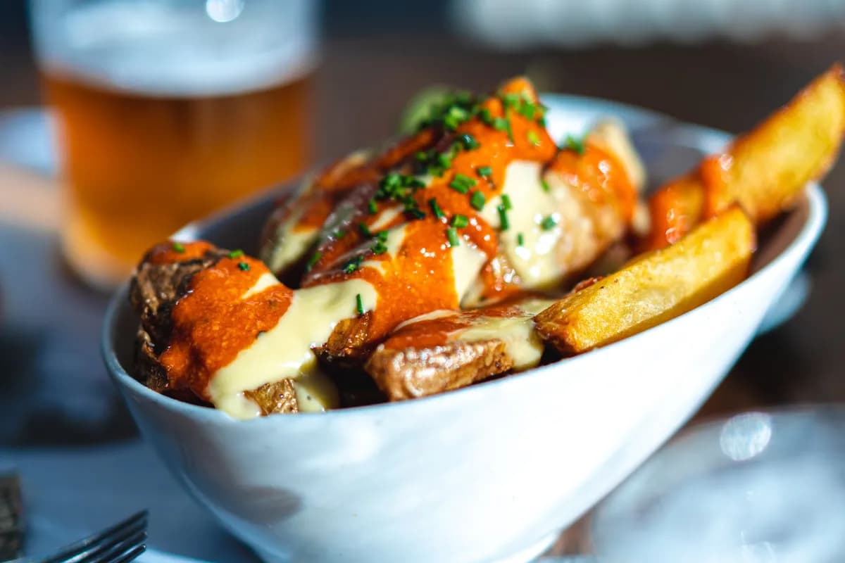 Bowl of poutine with gravy and cheese, a reminder that Wendy's poutine is not gluten free