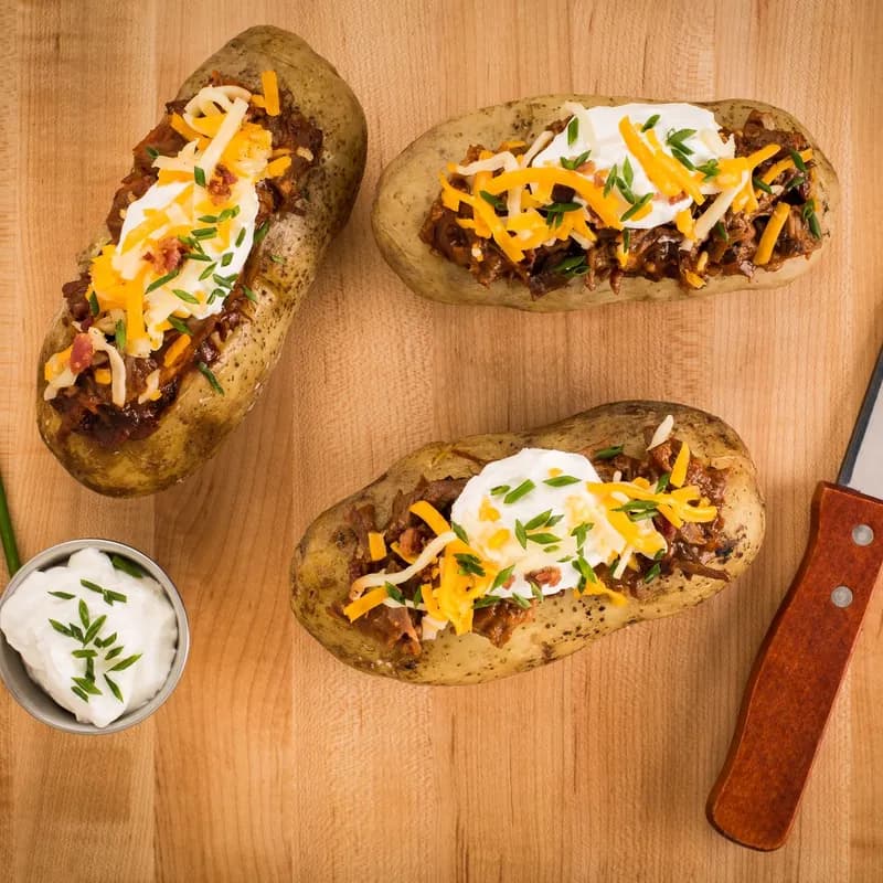 Loaded baked potatoes with sour cream and chives, a heavier option than a plain baked potato