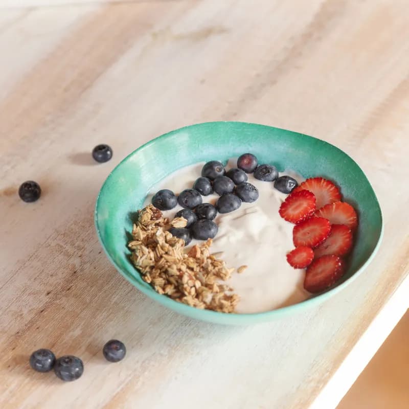 Yogurt bowl with fresh berries as a home gluten free breakfast idea, check granola labels
