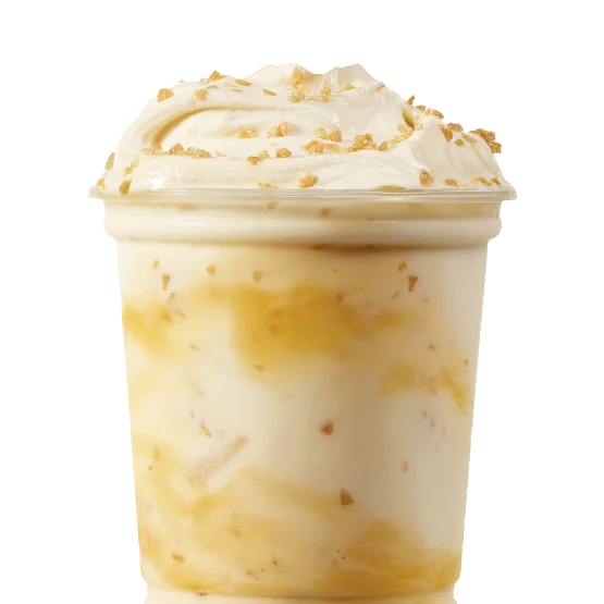 Wendy’s Caramel Crunch Vanilla Frosty Fusion™ with caramel swirls and crunchy candy pieces in a vanilla Frosty cup.