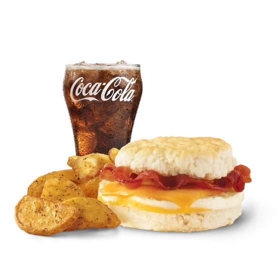 Wendy’s Bacon, Egg & Cheese Biscuit Combo with crispy bacon, fluffy egg, and melted cheese on a buttery biscuit, served with seasoned breakfast potatoes and a drink.