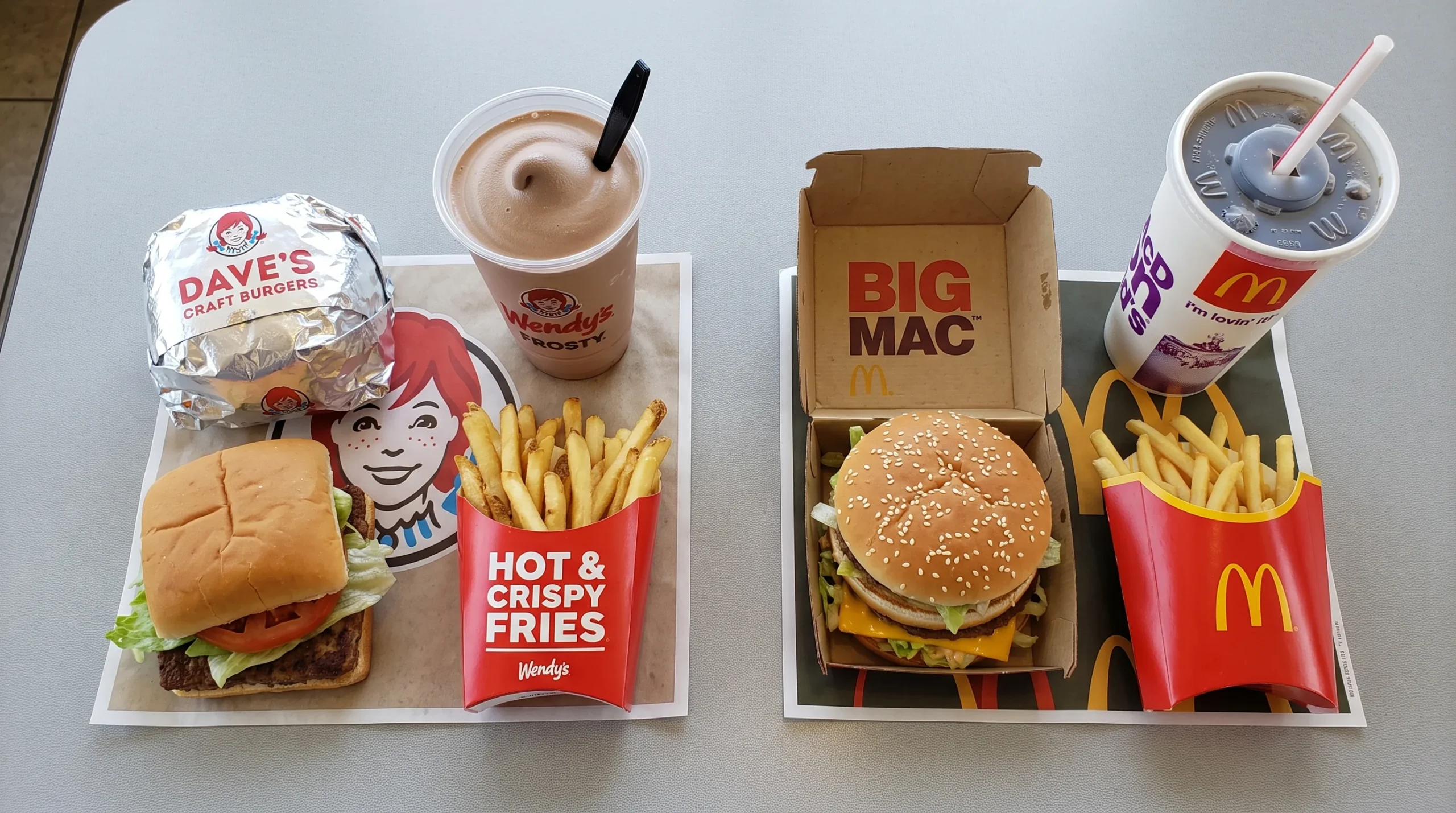 Wendy's combo meal with a square burger and Frosty next to a McDonald's combo meal